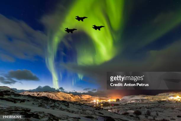 fighters on the background of the northern lights. military aviation - missile defense command stock pictures, royalty-free photos & images