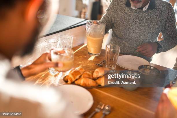 diverse family breakfast gathering with grandparents and children - family and happiness and diverse imagens e fotografias de stock