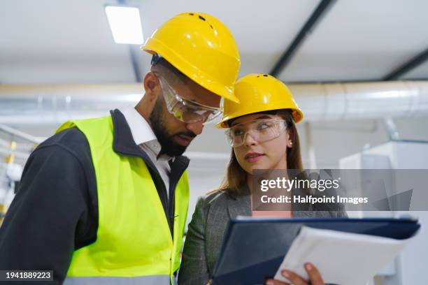 consultant explaining manager safety procedures, hazards, providing training. concept of occupational safety and health in workplace. - clipboard and glasses imagens e fotografias de stock