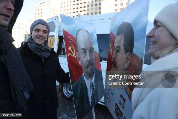 Participants hold portraits of Soviet leaders Joseph Stalin and Vladimir Lenin during the rally, hosted by the Russian Communist Party CPRF, on...