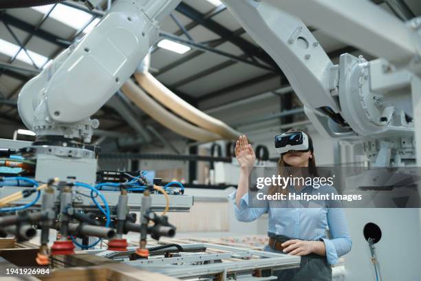 female engineer using vr, in modern industrial factory. virtual reality and technology in manufacturing industry, smart glasses guiding manager through process and planing. - rpa stock pictures, royalty-free photos & images