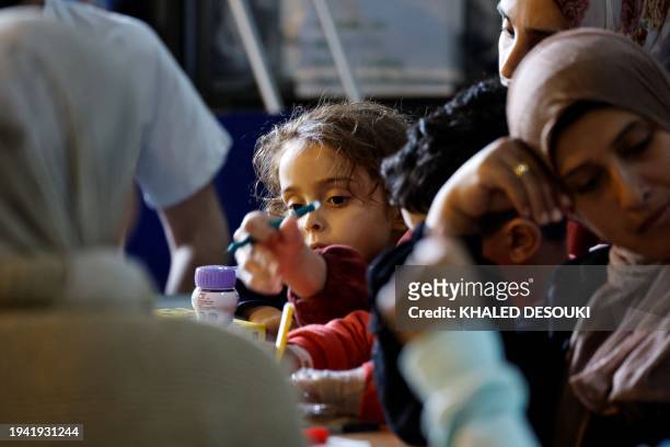 Palestinian child plays onboard the French LHD Dixmude military ship, which serves as a hospital to treat wounded Palestinians, as it docks at the...