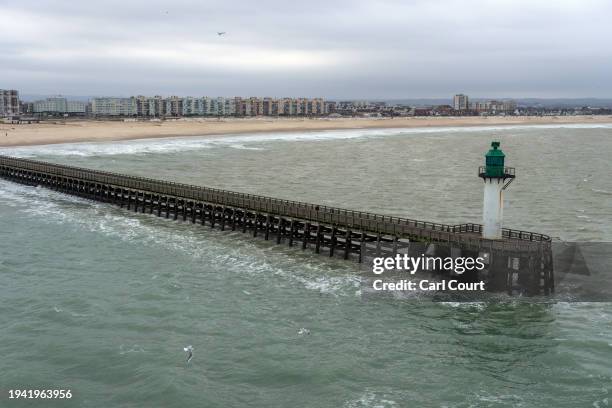 Lighthouse operates at the end of a harbour arm on January 21, 2024 in Calais, France. The first boats of 2024 carrying migrants across the English...