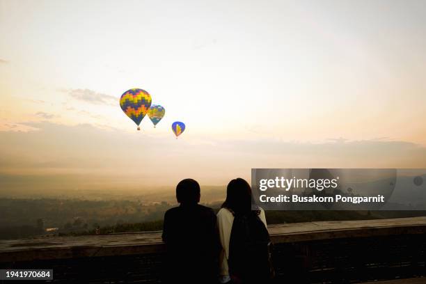 young couple relax on hills at sunrise - mae hong son province stock pictures, royalty-free photos & images