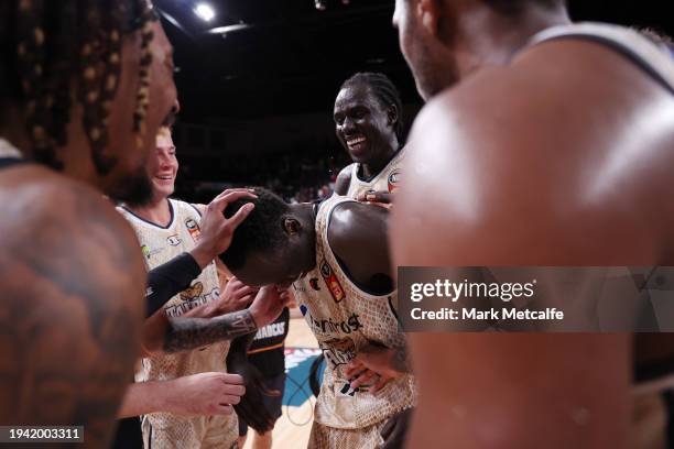 Lat Mayen of the Taipans celebrates victory with team mates after scoring the winning basket during the round 16 NBL match between Illawarra Hawks...