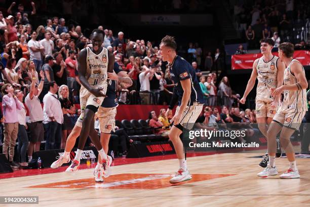 Lat Mayen of the Taipans celebrates victory with team mates after scoring the winning basket during the round 16 NBL match between Illawarra Hawks...