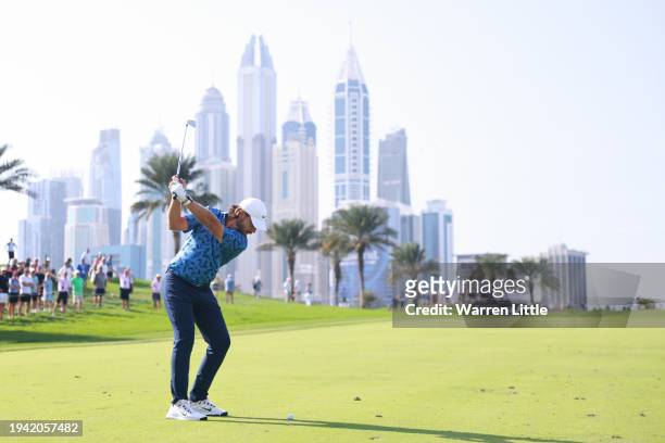Tommy Fleetwood of England plays his second shot on the eighth hole during Round One of the Hero Dubai Desert Classic at Emirates Golf Club on...