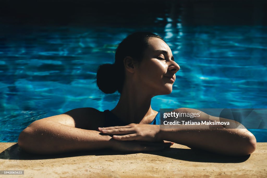 Beautiful young woman in swimming pool.