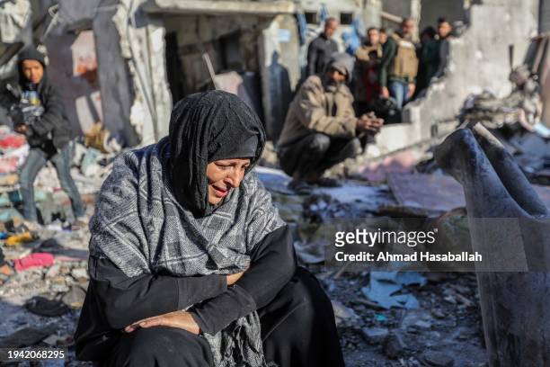 Woman sits amongst damaged homes caused by Israeli air strikes, on January 18, 2024 in Rafah, Gaza. Israel increased air raids in the south of the...