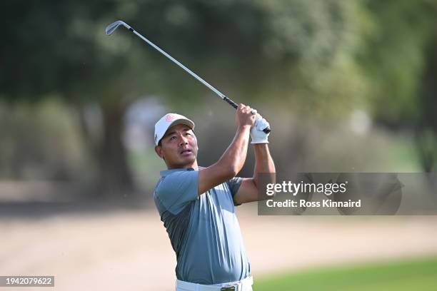 Ashun Wu of China plays his second shot on the 12th hole on day one of the Hero Dubai Desert Classic at Emirates Golf Club on January 18, 2024 in...