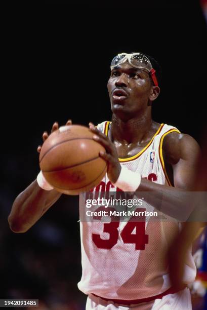 Hakeem Olajuwon#34, Center for the Houston Rockets prepares to make a free throw shot during the NBA Midwest Division basketball game against the...