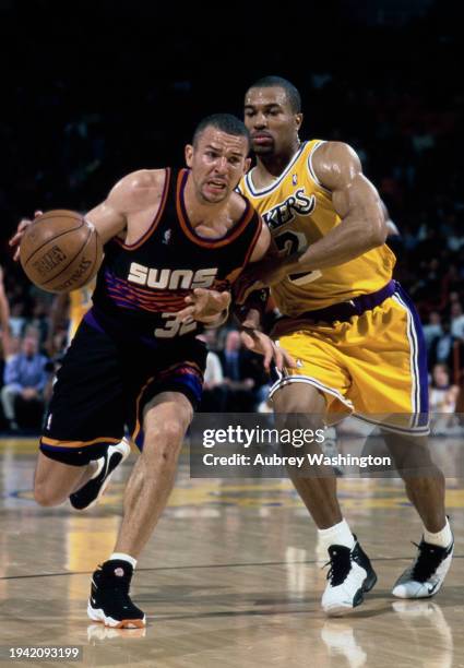 Jason Kidd, Point Guard and Shooting Guard in motion dribbling the basketball around Derek Fisher, Point Guard and Shooting Guard for the Los Angeles...