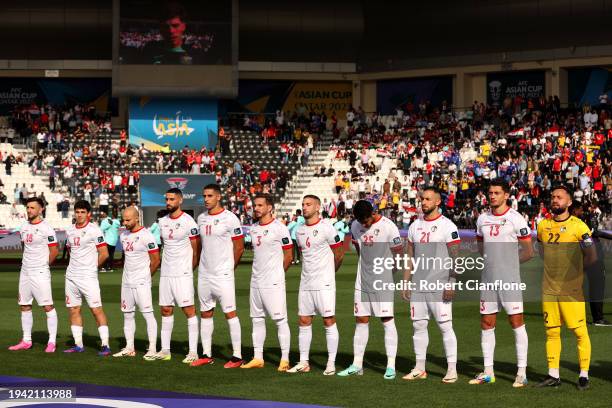 Players of Syria stand for the national anthem prior to the AFC Asian Cup Group B match between Syria and Australia at Jassim Bin Hamad Stadium on...