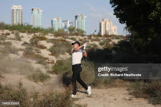Daniel Hillier of New Zealand plays a shot from the rough on the 12th hole during Round One of the Hero Dubai Desert Classic at Emirates Golf Club on...