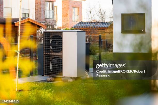 a heat pump in front of an apartment block in duesseldorf, germany, europe - wärmepumpe stock-fotos und bilder