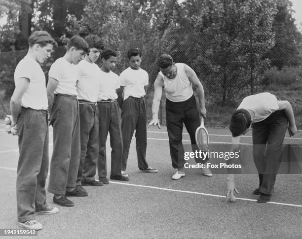 As Graham Bishop shows how to gather the ball, Robert Newton, PT Master, explains the technique to the other students, who are training to become...
