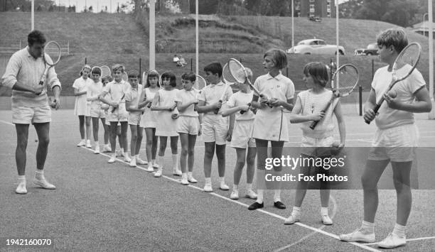 During the summer holidays, Coach Alan Cross teaching 9-10 years old children from South London schools in a mixed tennis class at the Crystal Palace...