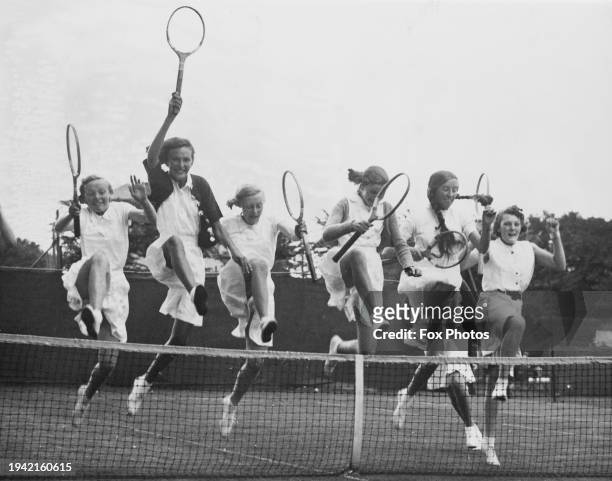 Group of young tennis players jumping over the tennis net during the second annual West Cheshire Junior Championship at Upton Wirrel, Birkenhead,...