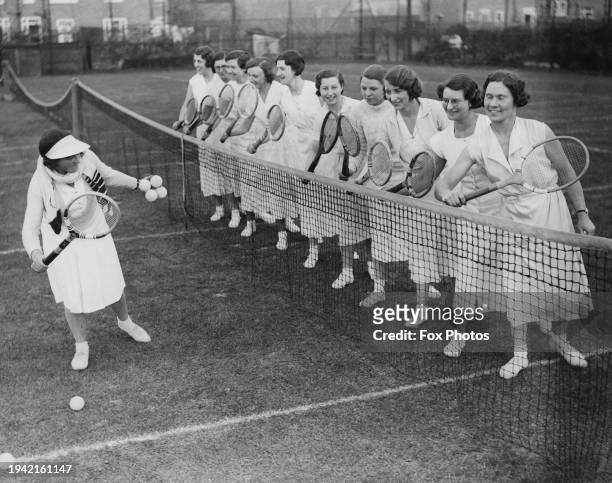 Tennis coach Vesta Smith teaching the basics of tennis to members of an Insurance Athletic Club, London, UK, 17th May 1935.