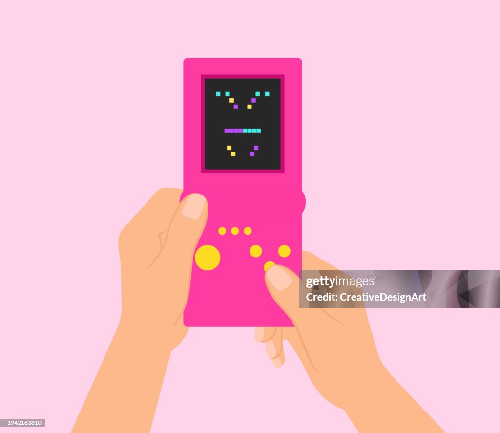 Hand Holding Retro Game Console And Playing Block Stacking Video Game