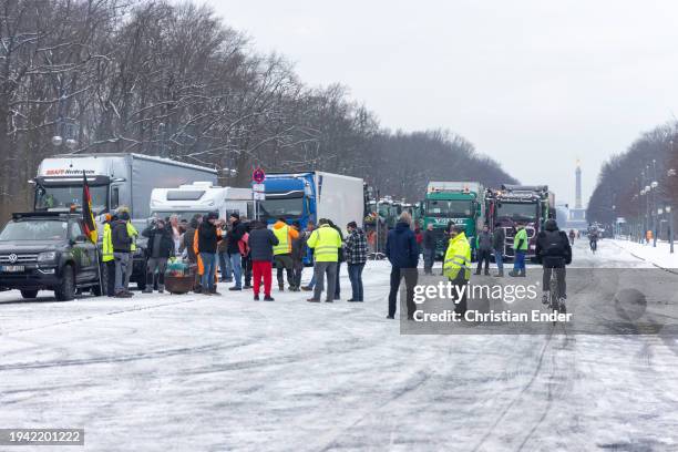 Truckers begin to gather in the city center to protest against government measures as the Victory Column landmark stands behind on January 18, 2024...