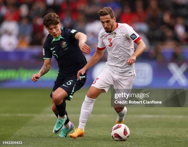 Moayad Ajan of Syria battles for possession with Jordan Bos of Australia during the AFC Asian Cup Group B match between Syria and Australia at Jassim...