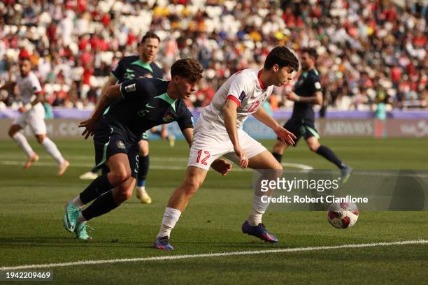 Ammar Ramadan of Syria battles for possession with Jordan Bos of Australia during the AFC Asian Cup Group B match between Syria and Australia at...