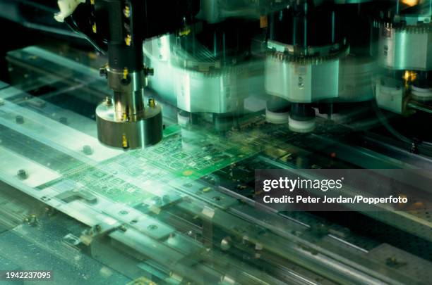 Panasert chip placement machine checks integrated circuit microchips mounted on a circuit board on a sealed production line at the Panasonic...