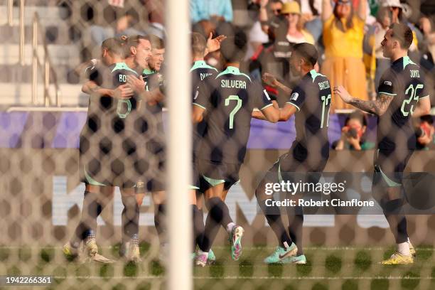 Jackson Irvine of Australia celebrates with team mates scoring his team's first goal during the AFC Asian Cup Group B match between Syria and...