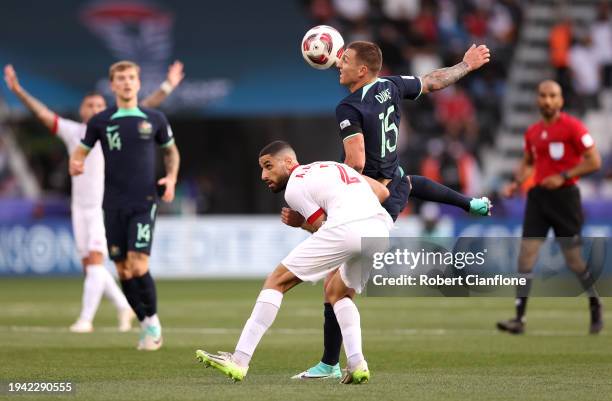 Mitchell Duke of Australia battles for possession with Aiham Ousou of Syria during the AFC Asian Cup Group B match between Syria and Australia at...
