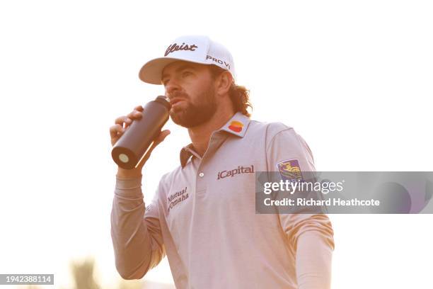 Cameron Young of the United States takes a drink on the 17th hole during Round One of the Hero Dubai Desert Classic at Emirates Golf Club on January...