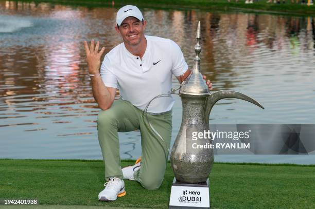 Rory McIlroy of Northern Ireland poses with his trophy after winning the Hero Dubai Desert Classic on the Majlis Course at the Emirates Golf Club in...