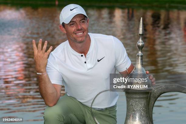 Rory McIlroy of Northern Ireland poses with his trophy after winning the Hero Dubai Desert Classic on the Majlis Course at the Emirates Golf Club in...