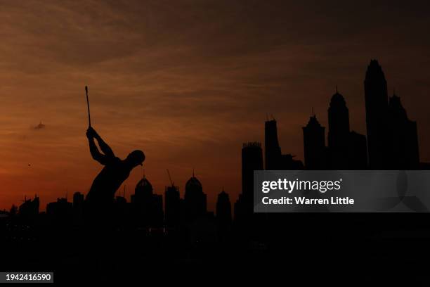 Silhouette as Thorbjorn Olesen of Denmark plays his second shot on the 18th hole during Round One of the Hero Dubai Desert Classic at Emirates Golf...