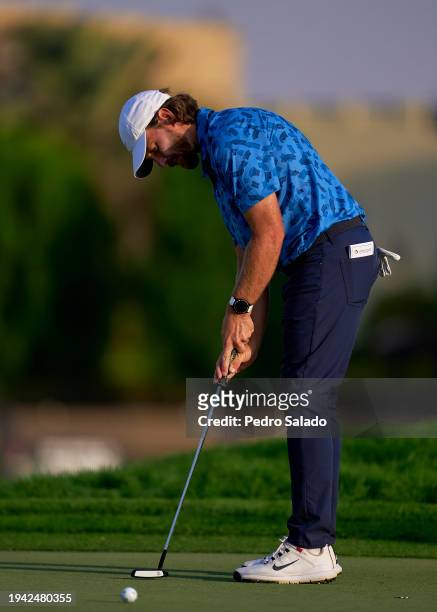 Tommy Fleetwood of England hits a putt on 14th green during the first round of the Hero Dubai Desert Classic on the Majlis Course at Emirates Golf...