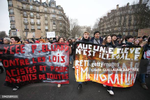 Demonstrators hold banners reading "Paul Eluard highschool against racist laws and for human rights of all" and "no student is illegal, retreat of...