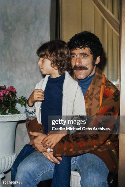 American actor Elliott Gould attends an event with his son Jason Gould, US, circa 1975.