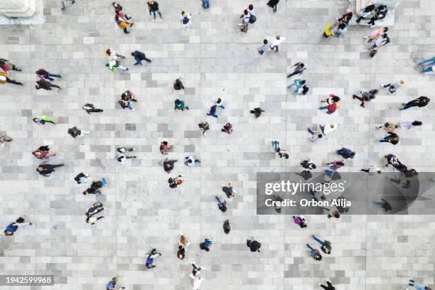 aerial shot of people walking - incidental people stock pictures, royalty-free photos & images