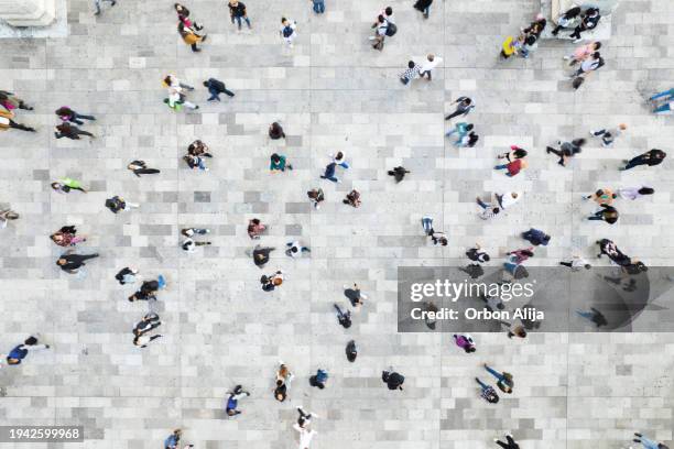 aerial shot of people walking - community work day stock pictures, royalty-free photos & images