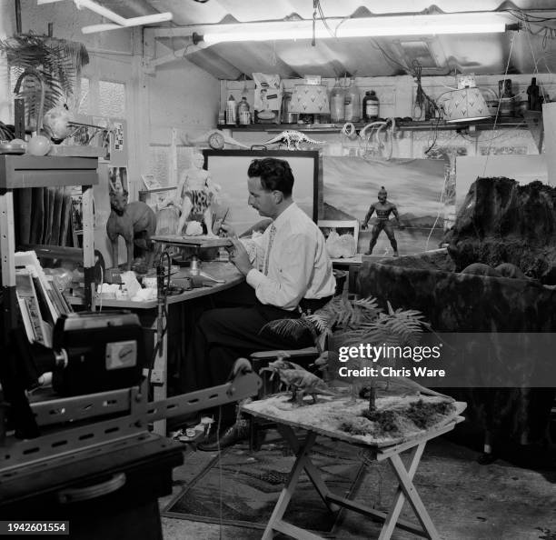 Artist Arthur Hayward sculpting the rubber model of a prehistoric man at his workshop in Perivale, London, September 1962. Hayward designed and...