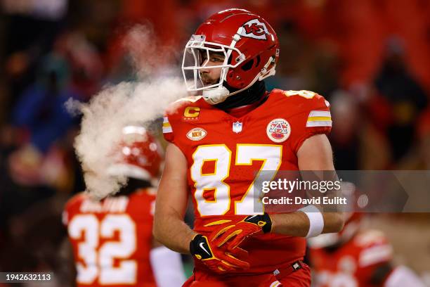 Travis Kelce of the Kansas City Chiefs looks on in the AFC Wild Card Playoffs against the Miami Dolphins at GEHA Field at Arrowhead Stadium on...