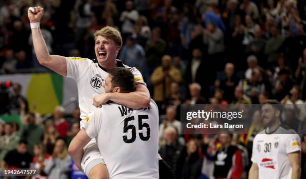 Lukas Hutecek of Austria celebrates with team mate Tobias Wagner during the Men's EHF Euro 2024 main round match between Hungary and Austria at...