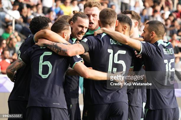 Jackson Irvine of Australia celebrates with team mates scoring his team's first goal during the AFC Asian Cup Group B match between Syria and...