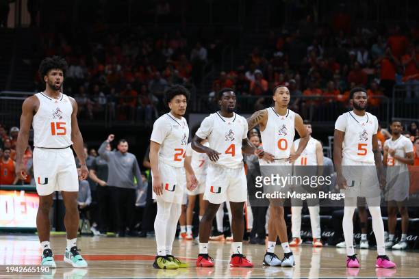 Norchad Omier, Nijel Pack, Bensley Joseph, Matthew Cleveland, and Wooga Poplar of the Miami Hurricanes look on during the second half of the game...
