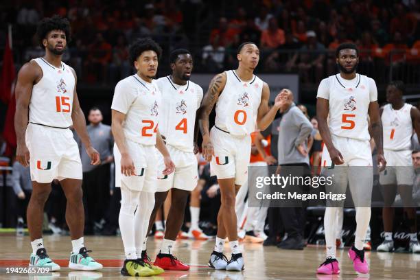 Norchad Omier, Nijel Pack, Bensley Joseph, Matthew Cleveland, and Wooga Poplar of the Miami Hurricanes look on during the second half of the game...