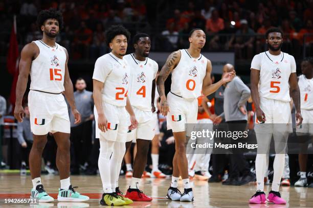 Norchad Omier, Nijel Pack, Bensley Joseph, Matthew Cleveland, and Wooga Poplar of the Miami Hurricanes look on during the second half of the game...