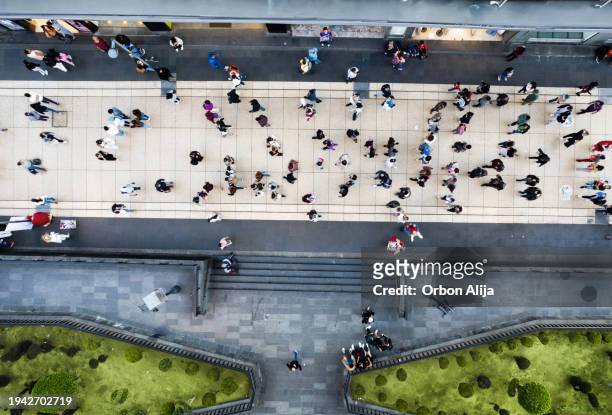 aerial shot of people walking - looking down road stock pictures, royalty-free photos & images