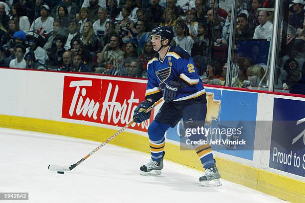 Al MacInnis of the St. Louis Blues plays the puck against the Vancouver Canucks during the first round of the 2003 Stanley Cup playoffs at General...