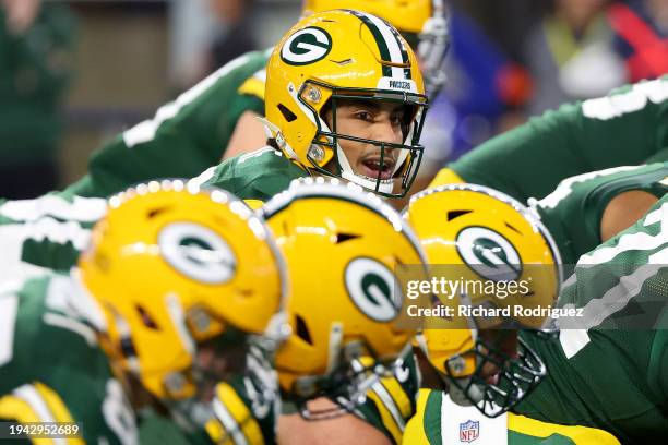 Jordan Love of the Green Bay Packers hikes the ball against the Dallas Cowboys during the second quarter of the NFC Wild Card Playoff game at AT&T...