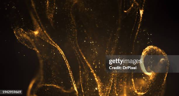 blurry glowing golden particle flow - nebula gold stock-fotos und bilder